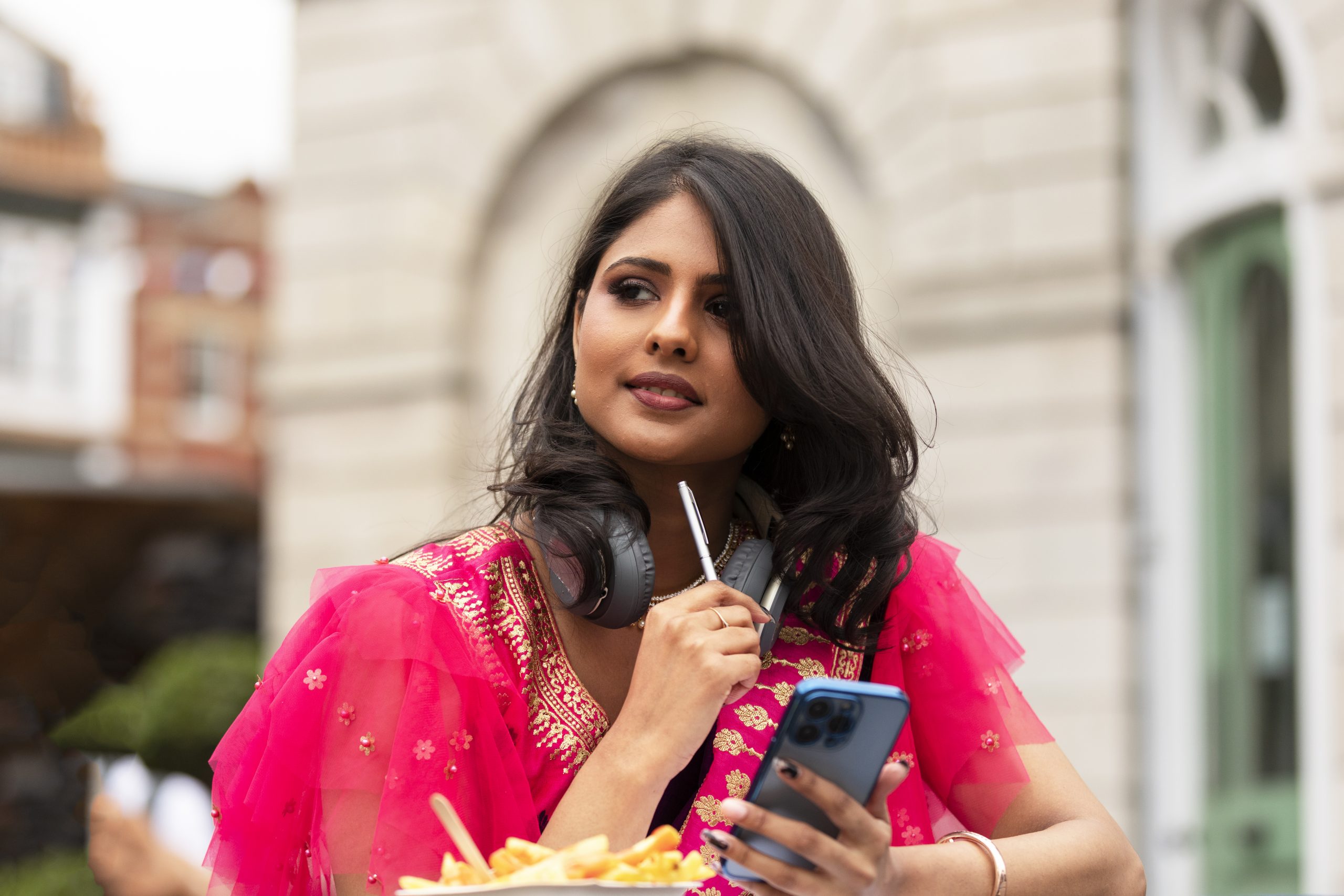 medium shot woman holding smartphone